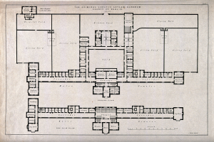 Schwarz-weißer Architekturplan eines Gebäudegrundrisses mit zahlreichen beschrifteten Räumen, darunter ein 'Irrenhaus für Kriminelle', begleitet von handgeschriebenem Text.