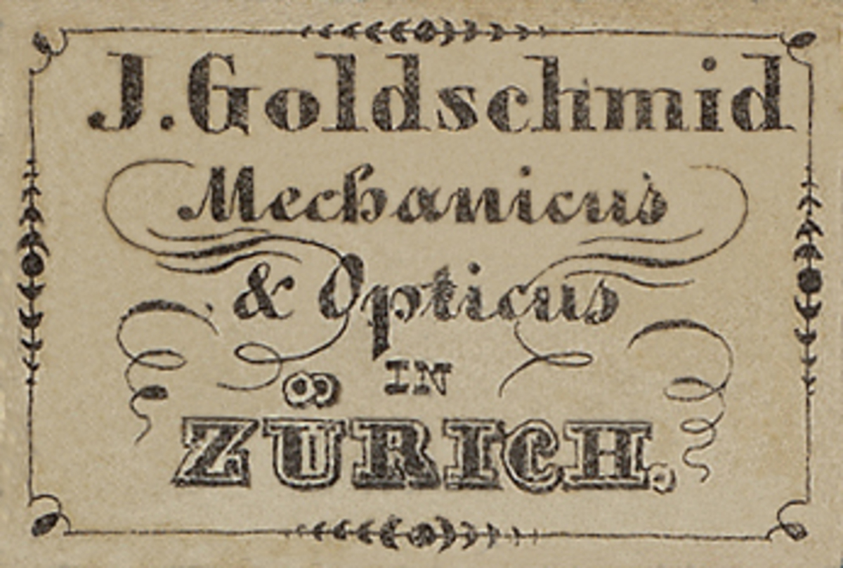 Eine alte Visitenkarte mit der Aufschrift "J. Goldschmidt Mechanicus & Optics in Zürich" aus dem frühen 20. Jahrhundert.